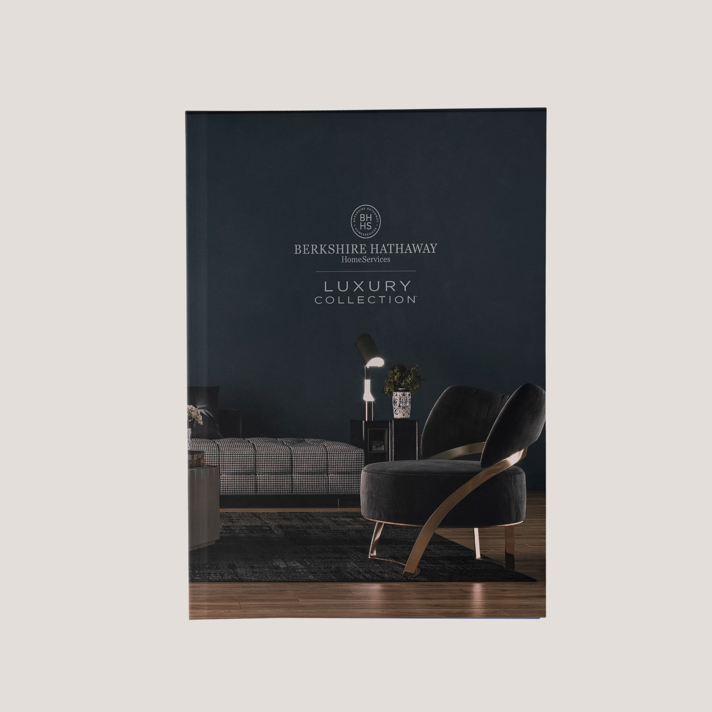 Cover of a Berkshire Hathaway HomeServices luxury furniture collection catalog with a dark interior design.