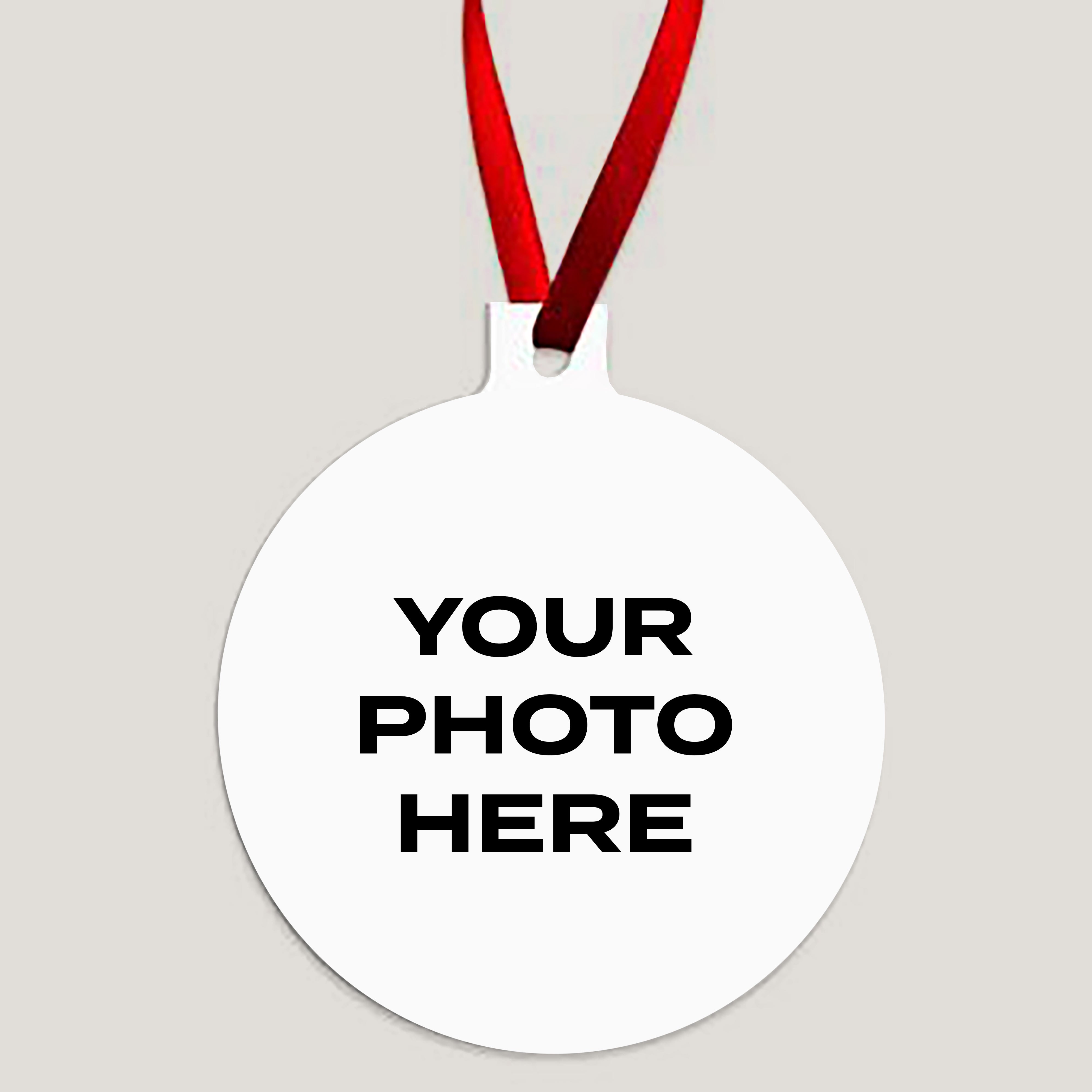 Customizable round metal ornament with red ribbon – add your photo to create a personalized Christmas decoration.
