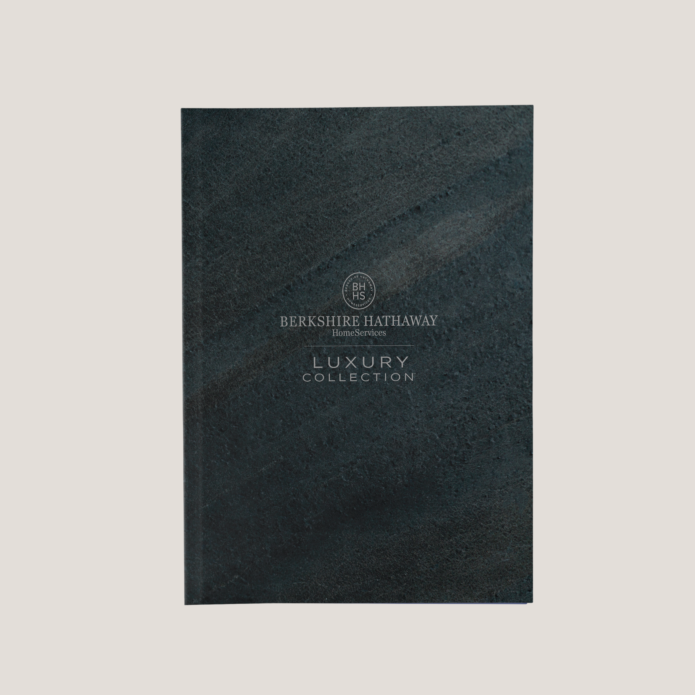 Dark textured notebook with 'Berkshire Hathaway' branding on a light gray background
