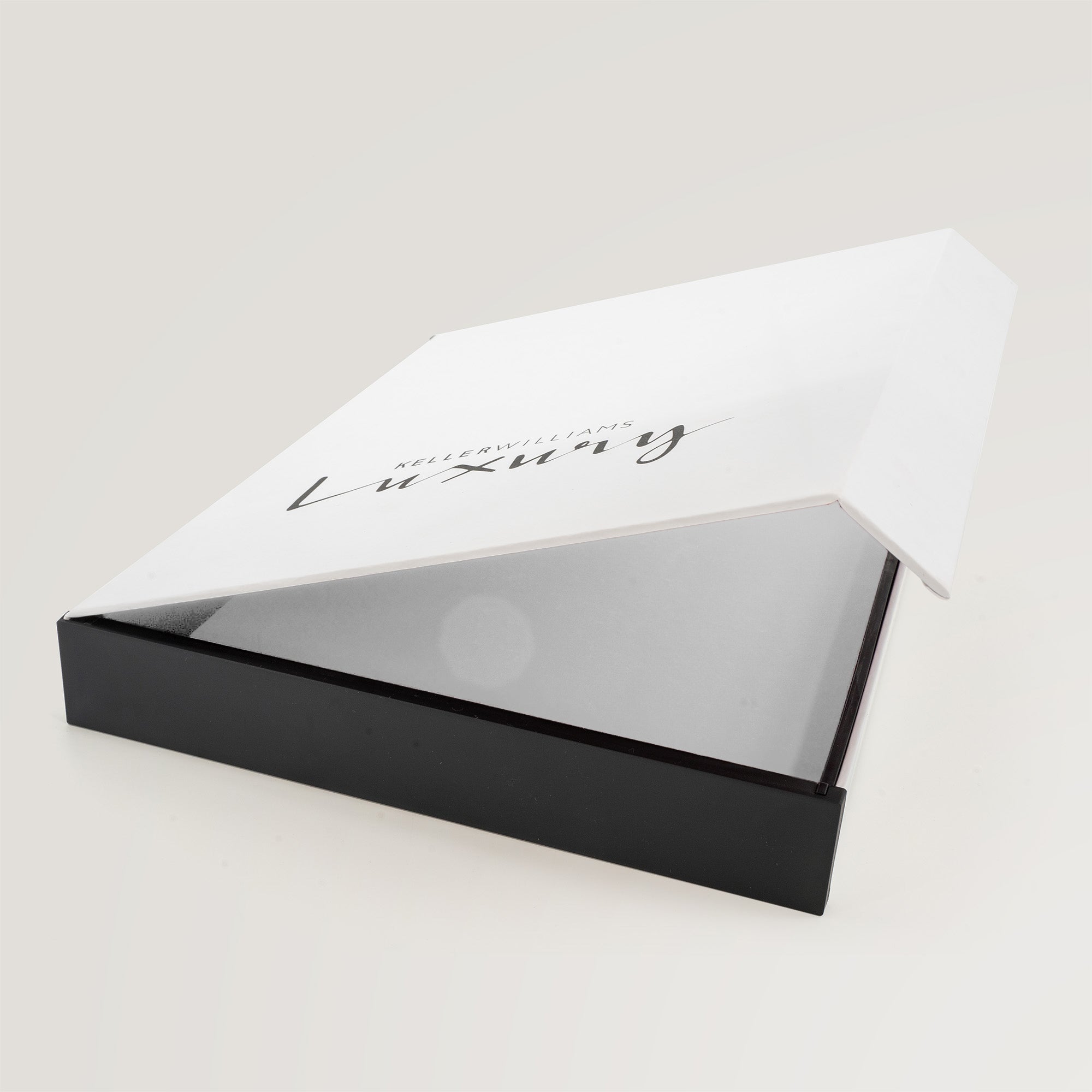 Open Keller Williams Luxury presentation box showing interior and black base.