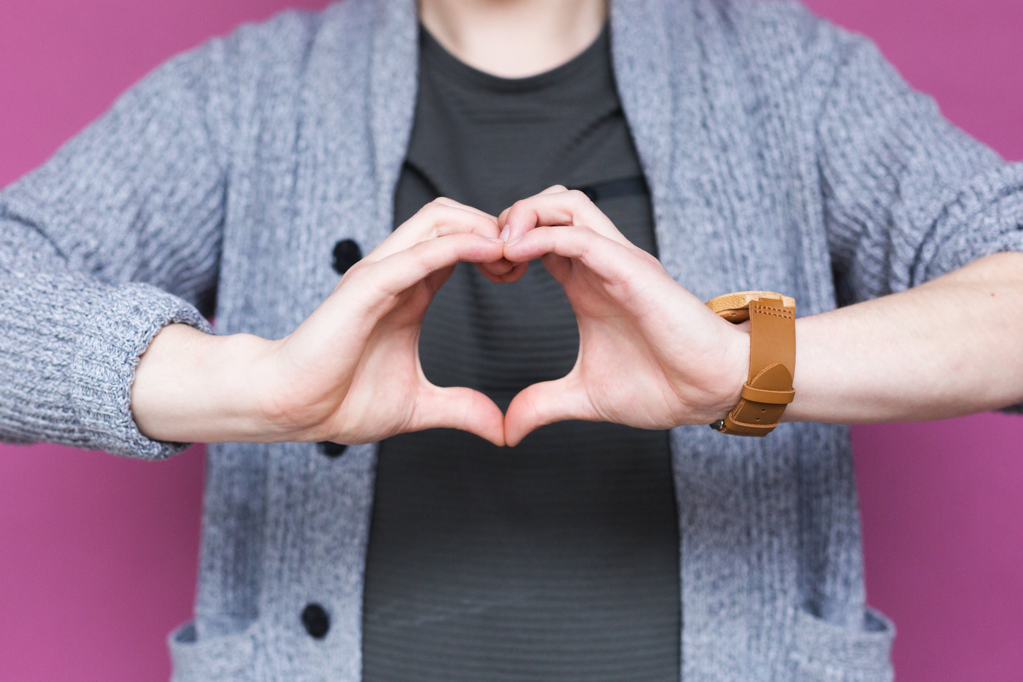Close-up of hands forming a heart shape symbolizing love and partnership for Peleman brand ambassador program