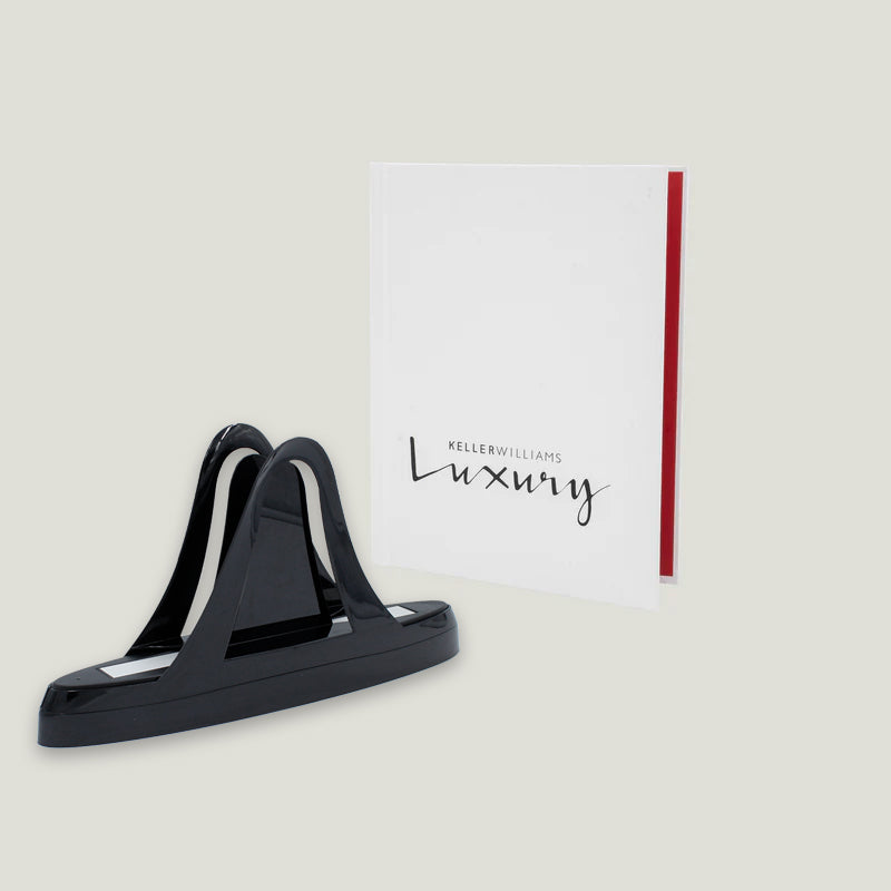 Peleman Unibind thermal binding machine next to custom Keller Williams Luxury hardcover