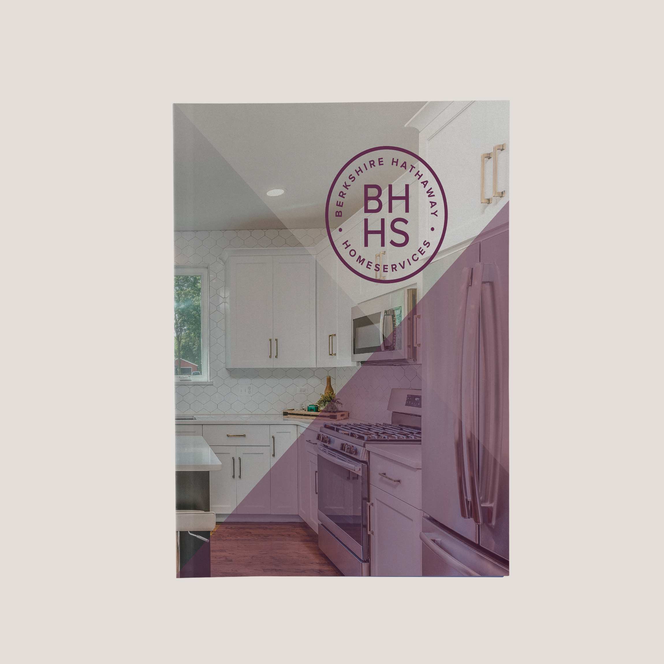 Modern kitchen with white cabinets and appliances, featuring the BHHS logo.