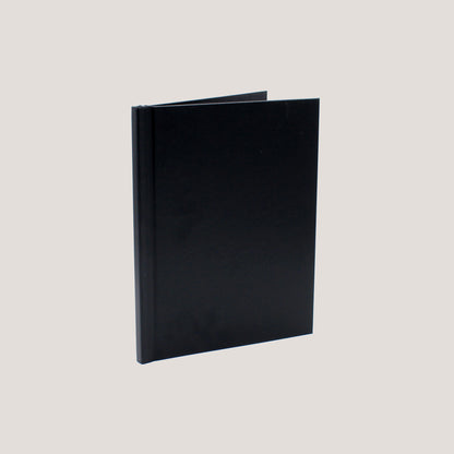 A black clamp binding photobook with a hard cover displayed open to show the binding mechanism.