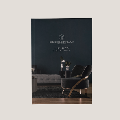 Cover of a Berkshire Hathaway HomeServices luxury furniture collection catalog with a dark interior design.