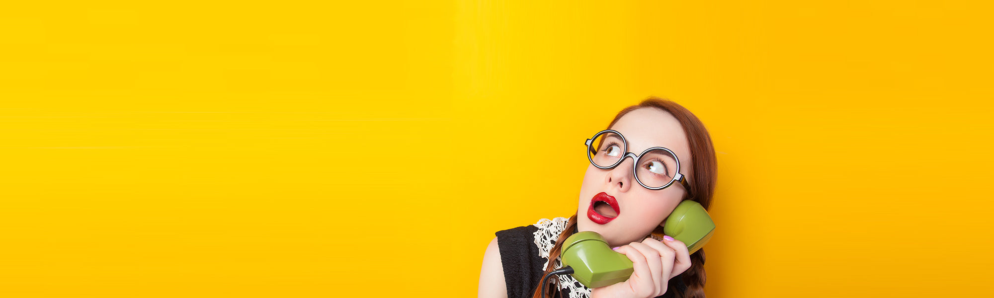 "Surprised young woman with retro glasses holding a green vintage phone against bright yellow background – Peleman Ambassador program banner image."