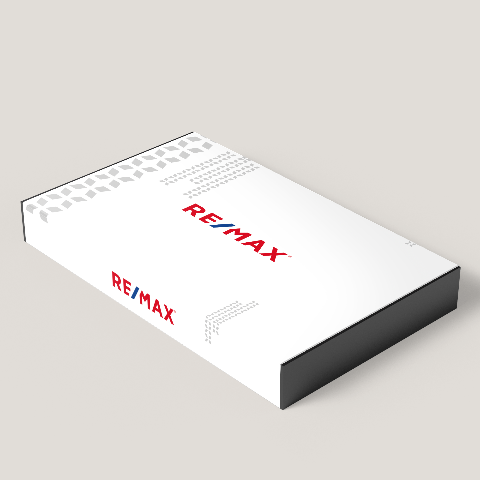 A white presentation box with the red RE/MAX logo on the lid, designed to look like a closed book.